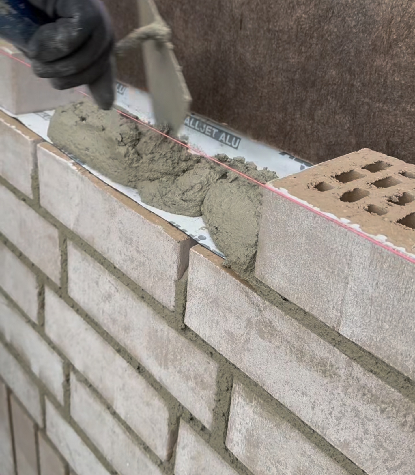Bricklaying in progress with mortar line in Oakville, GTA