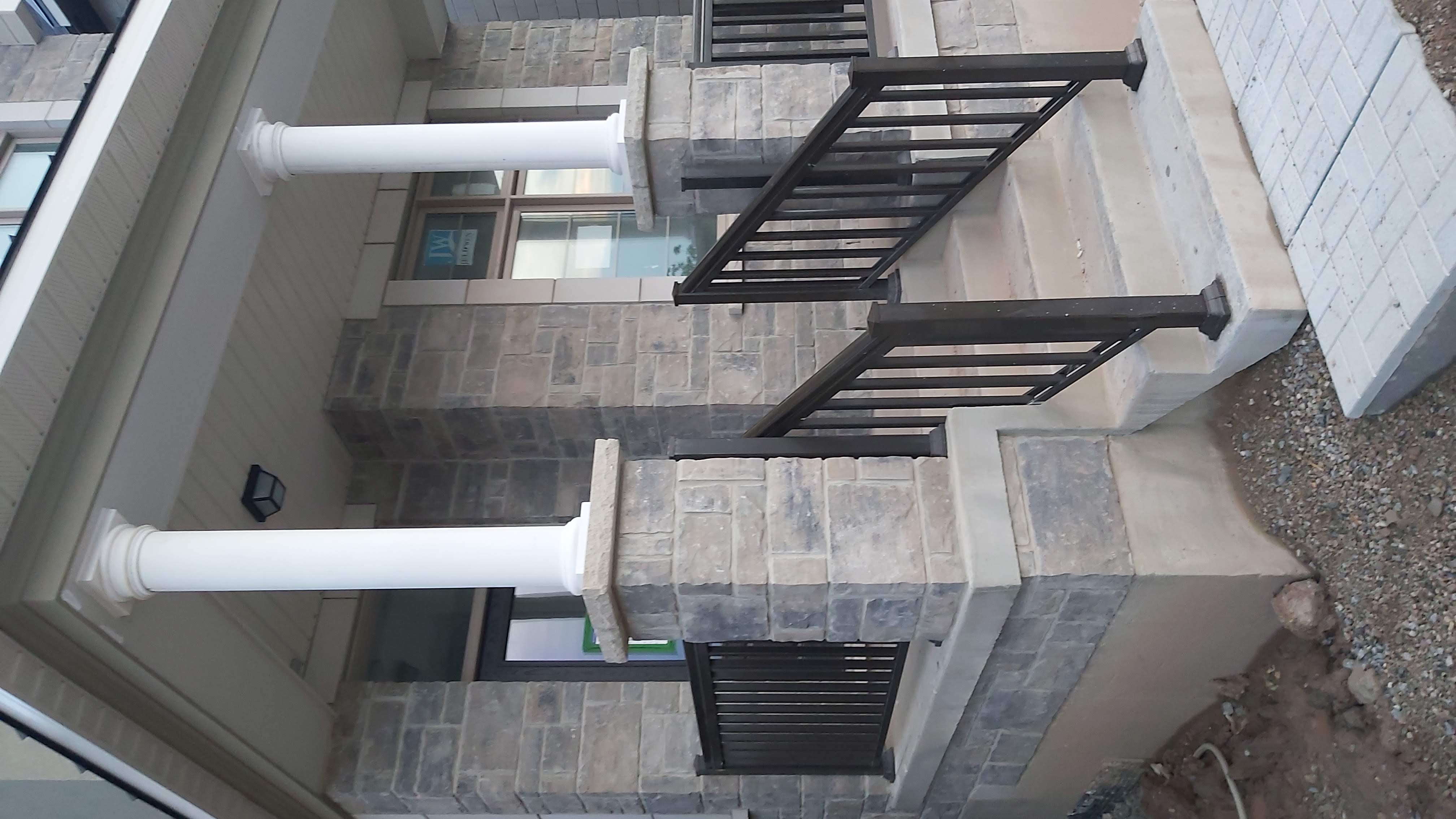 Stone-clad front porch columns on a custom home in Oakville, GTA — Olprrix Services