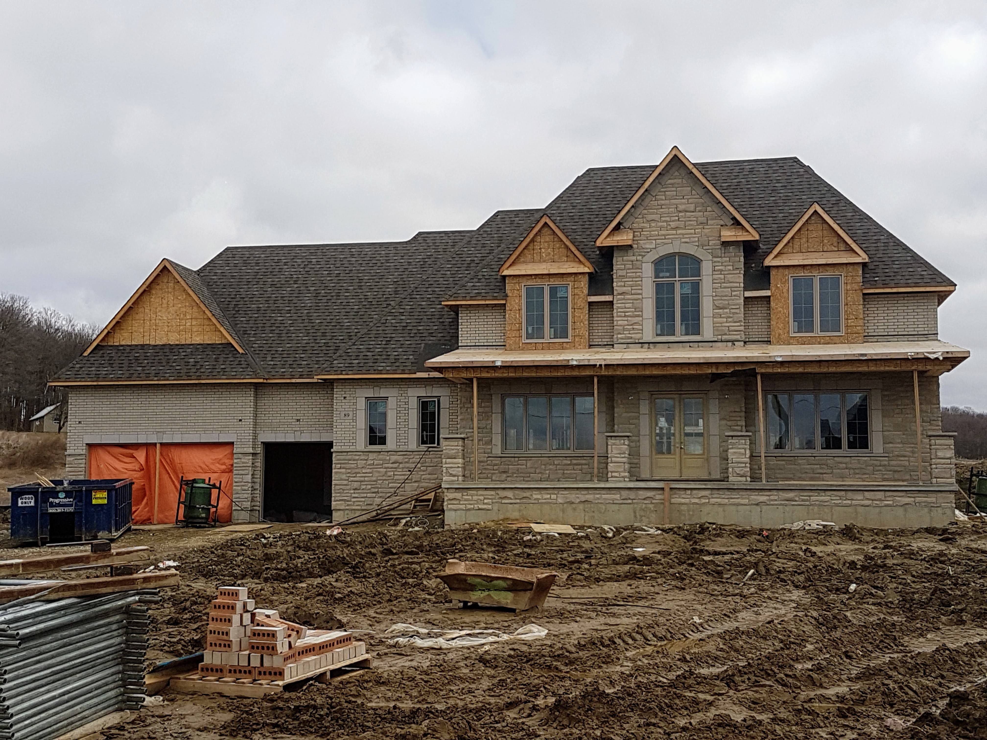 Brick and stone facade on a new custom home in Oakville, GTA